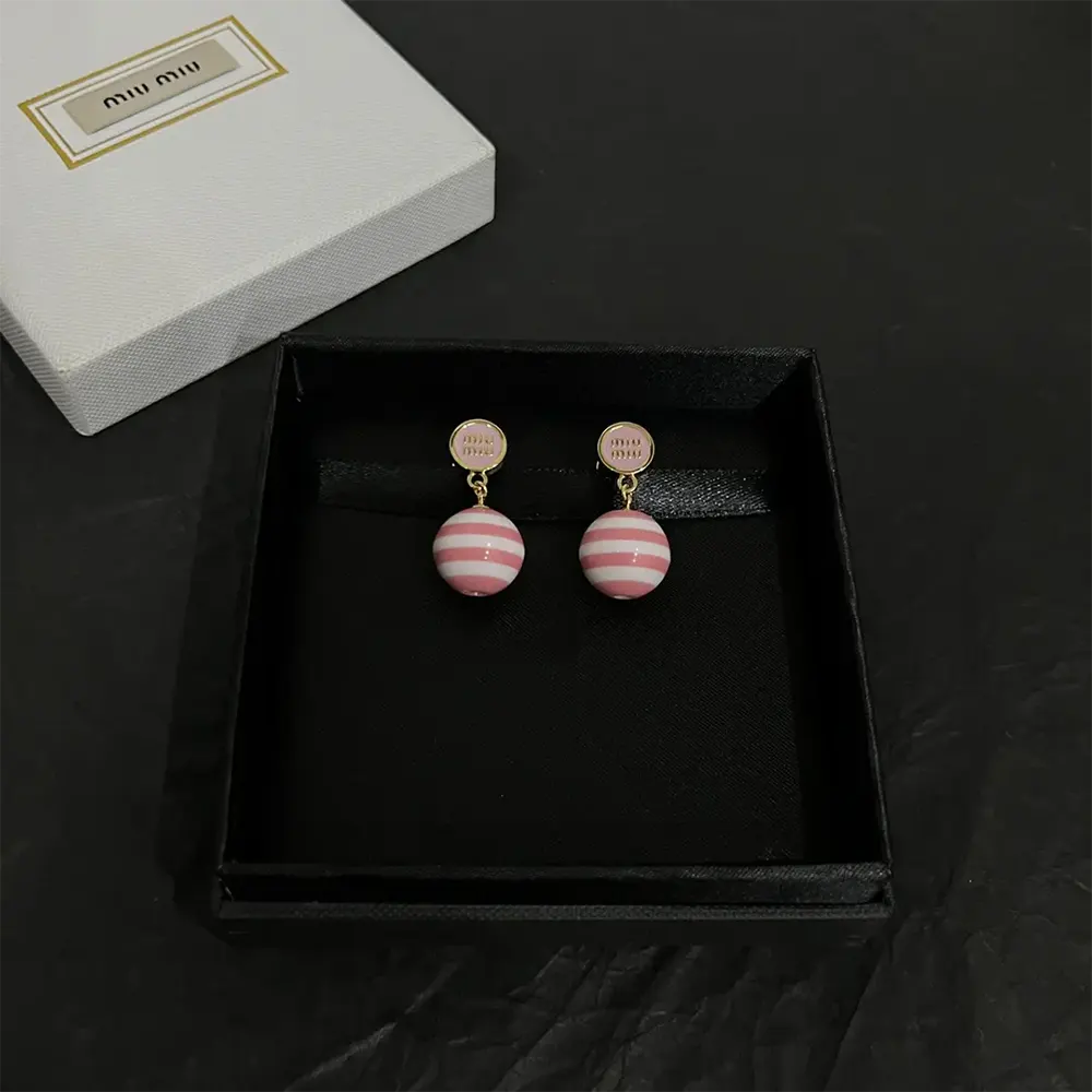 Close-up detail of pearl and metalwork on Miu Miu Women Metal and Pearl Earrings