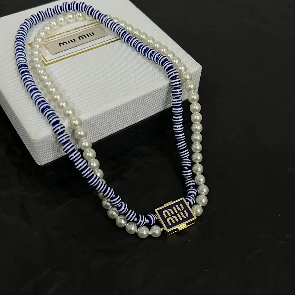 Close-up detail of synthetic pearls and metal on Miu Miu choker
