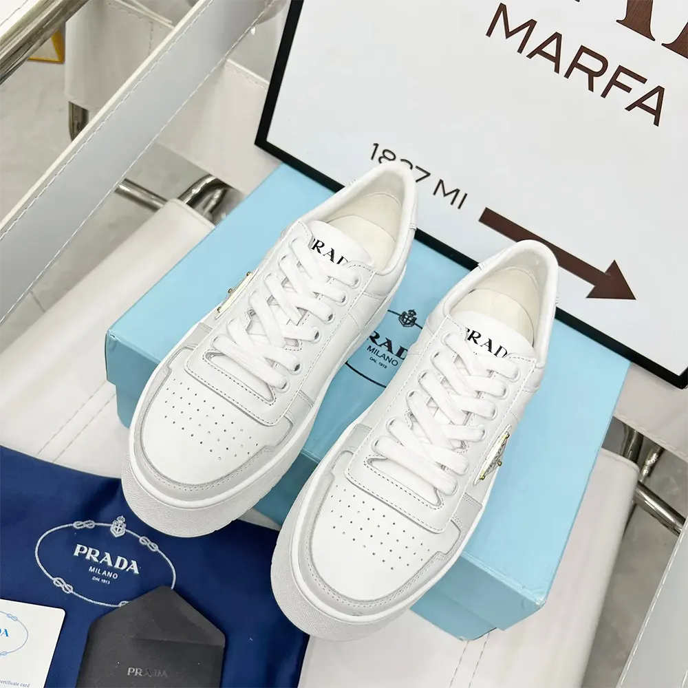 Close-up of metallic logo detail on Prada Women Downtown Bold Leather Sneakers