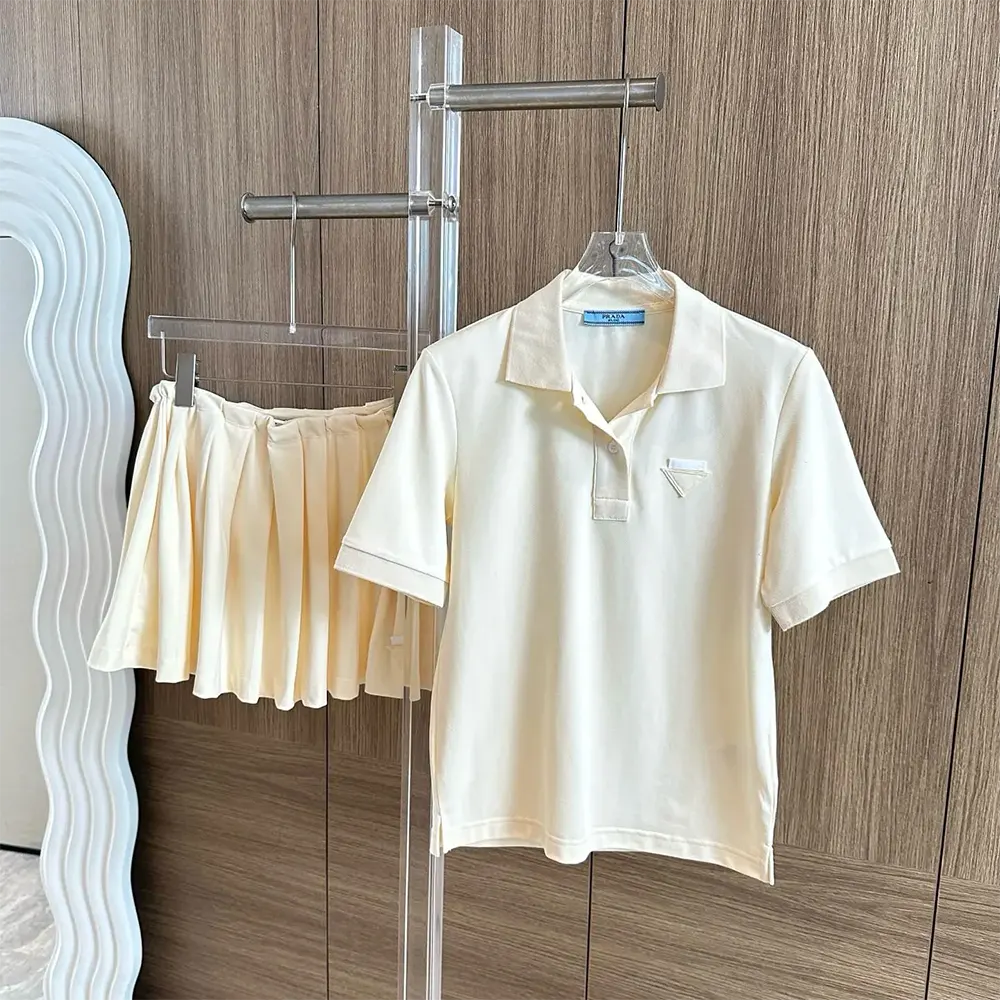 Close-up of Prada logo embroidered detail on beige polo shirt