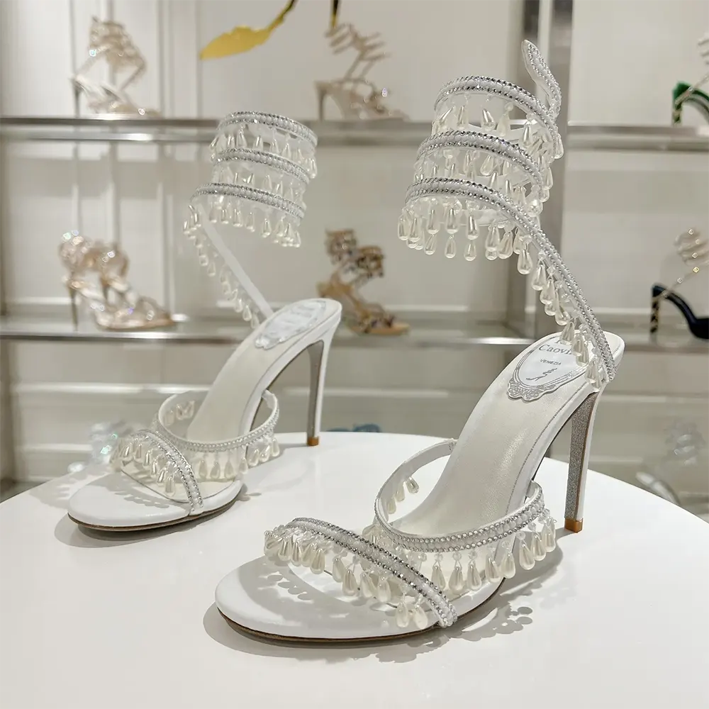 Rear angle showing satin ankle strap on Rene Caovilla Women Chandelier Ivory Sandal 105