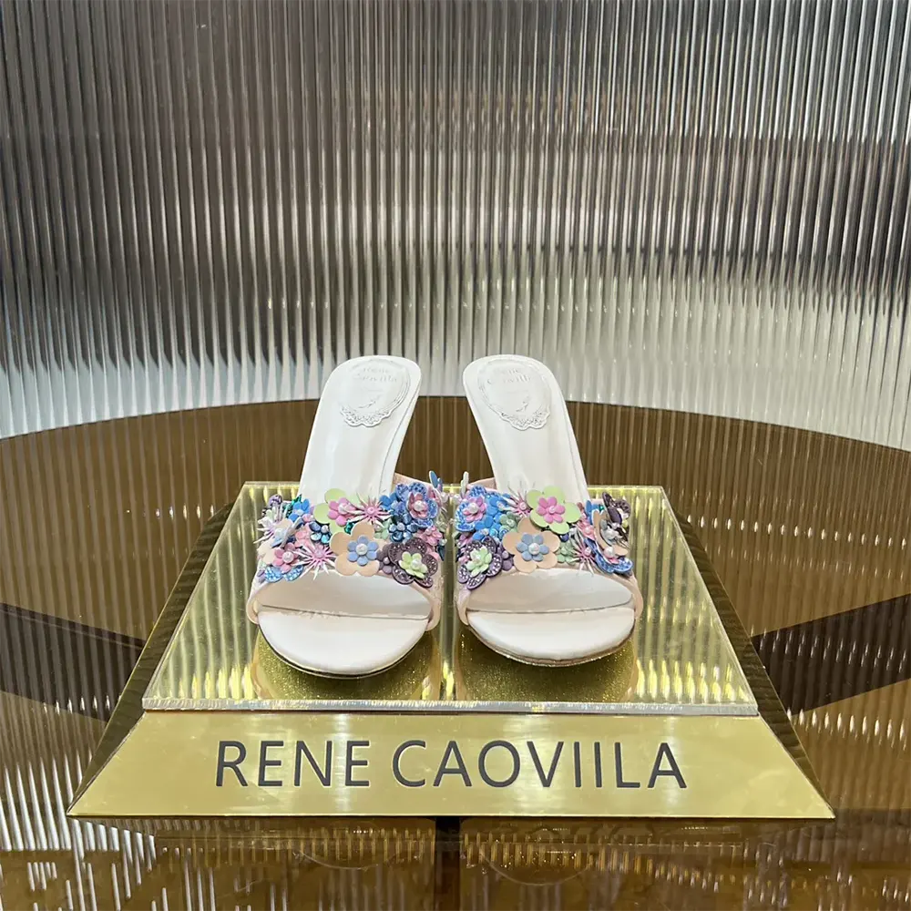 Close-up of crystal embellishments on Rene Caovilla Women Roxanne Nude Slider Sandal 80
