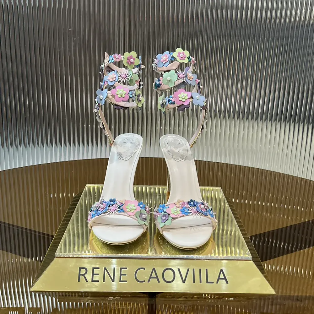 Close-up of floral appliqués on Rene Caovilla Roxanne Sandal pink satin