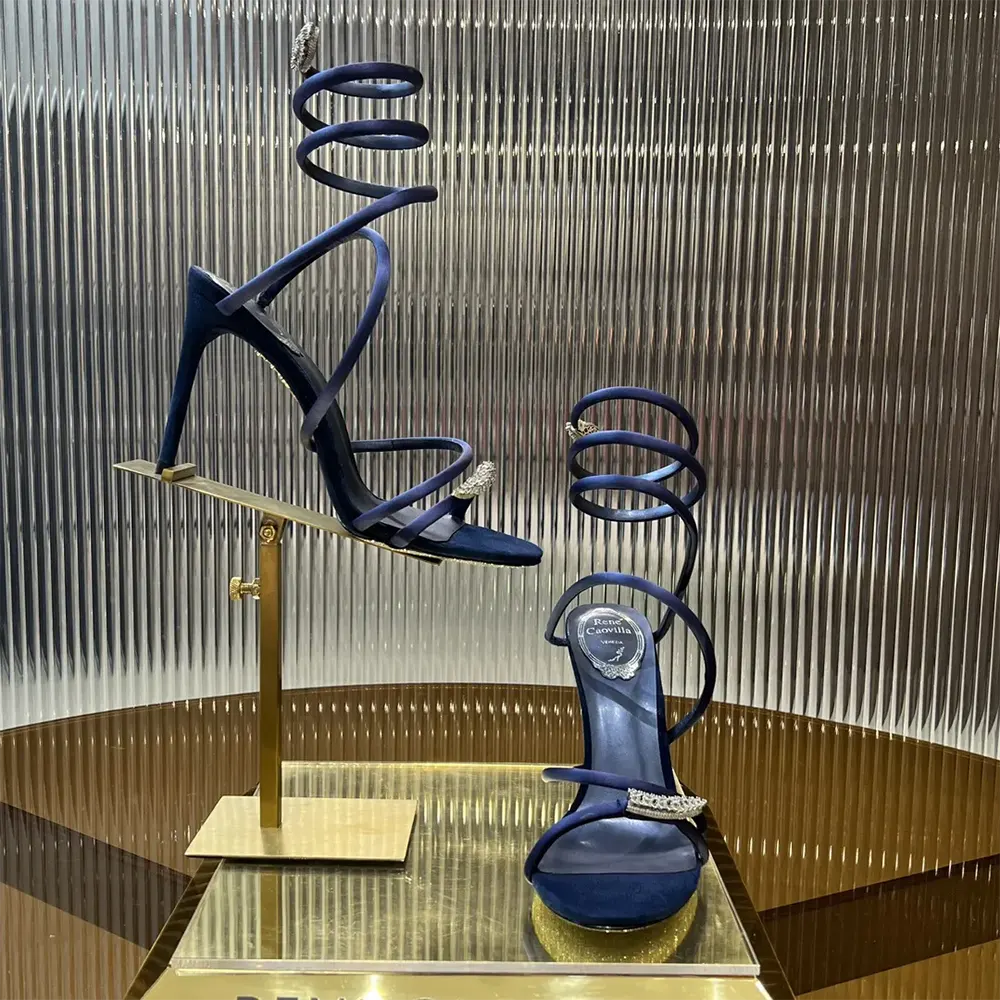 Top-down look at navy satin and stiletto heel of Rene Caovilla sandal