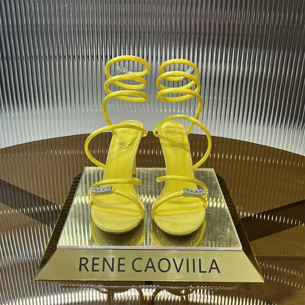 Close-up on crystal serpent detailing of the Rene Caovilla yellow sandal