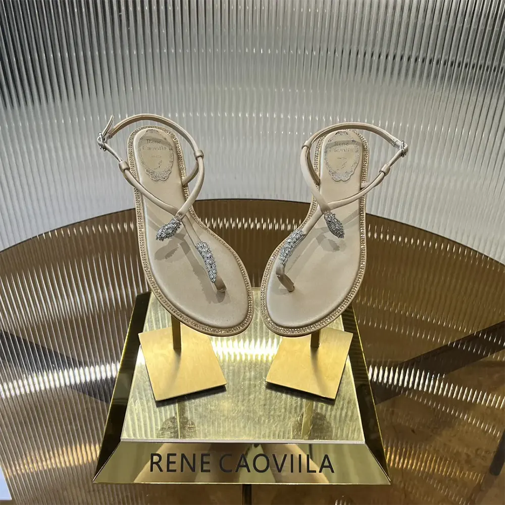 Top angle of Rene Caovilla Women Serpente Nude Thong Sandal 10 highlighting sandy leather texture