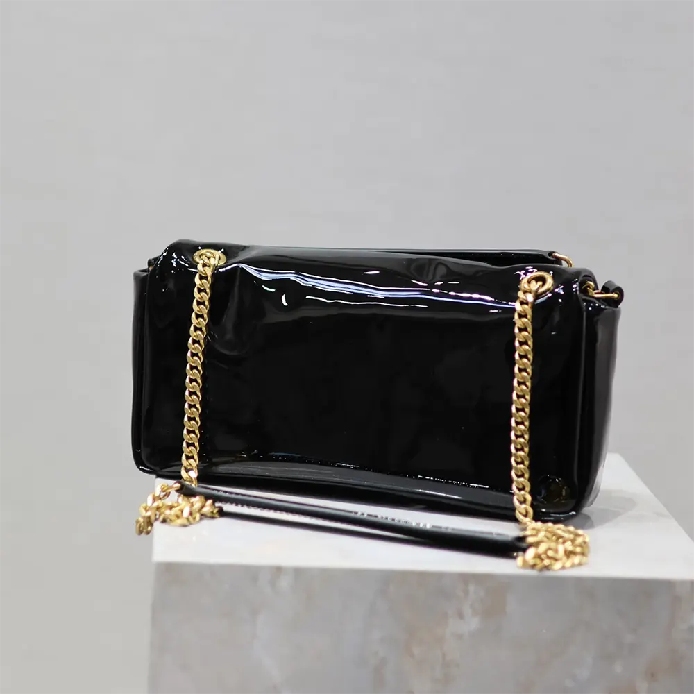 Side angle showing glossy black patent leather texture of Saint Laurent YSL Women Calypso Small