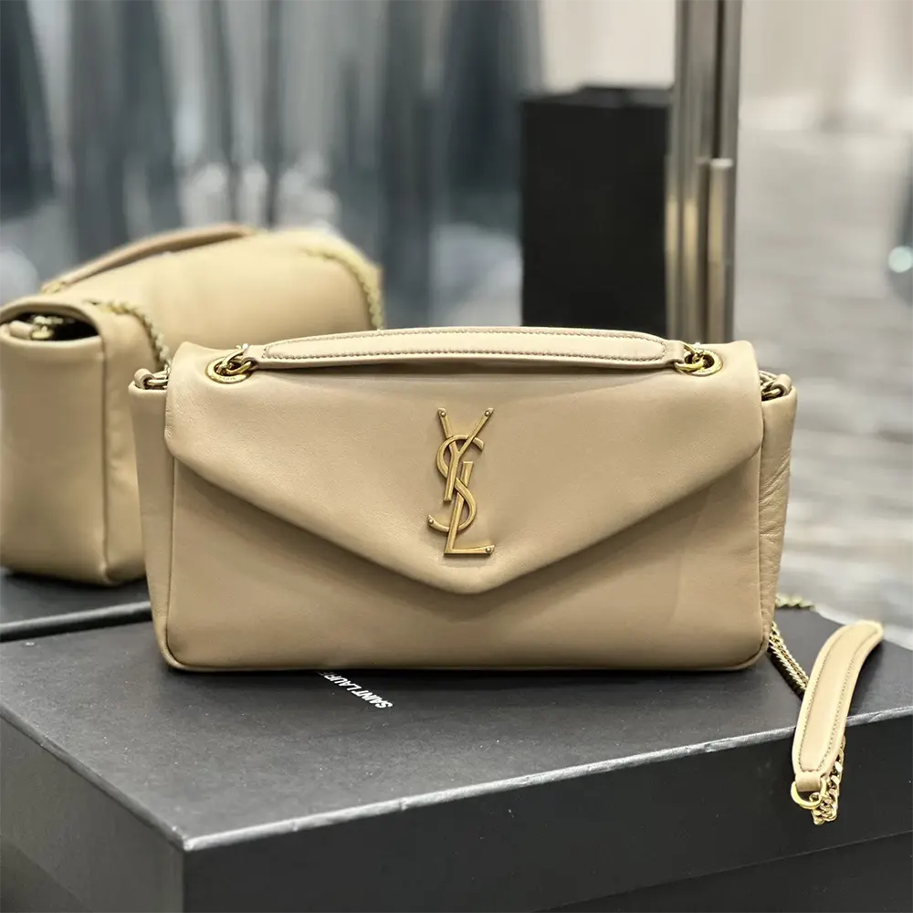 Close-up of gold YSL logo hardware on Saint Laurent YSL Women Calypso bag
