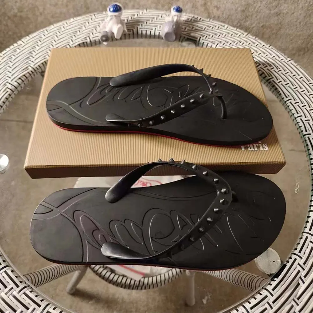 Top angle showing black leather upper of Christian Louboutin Men Loubi Donna Spike Flip Flops