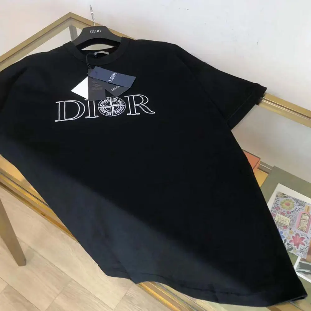 Side angle showing oversized fit of Dior Men Dior and Stone Island black T-shirt