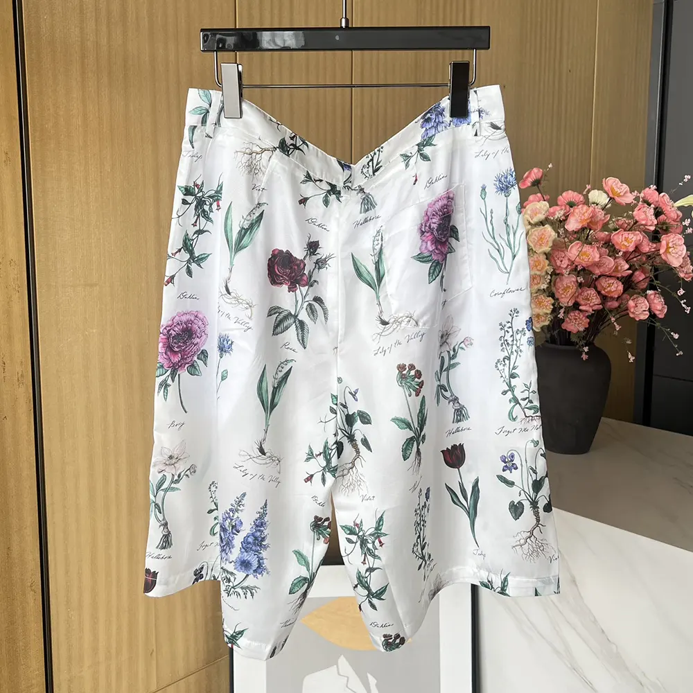 Side angle showing relaxed silhouette of Dior herbarium illustration bermuda shorts