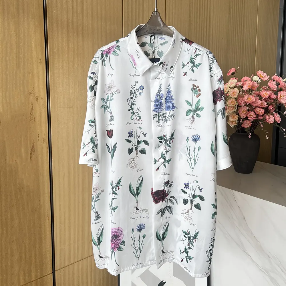 Close-up detail of Dior signature herbarium print on white shirt