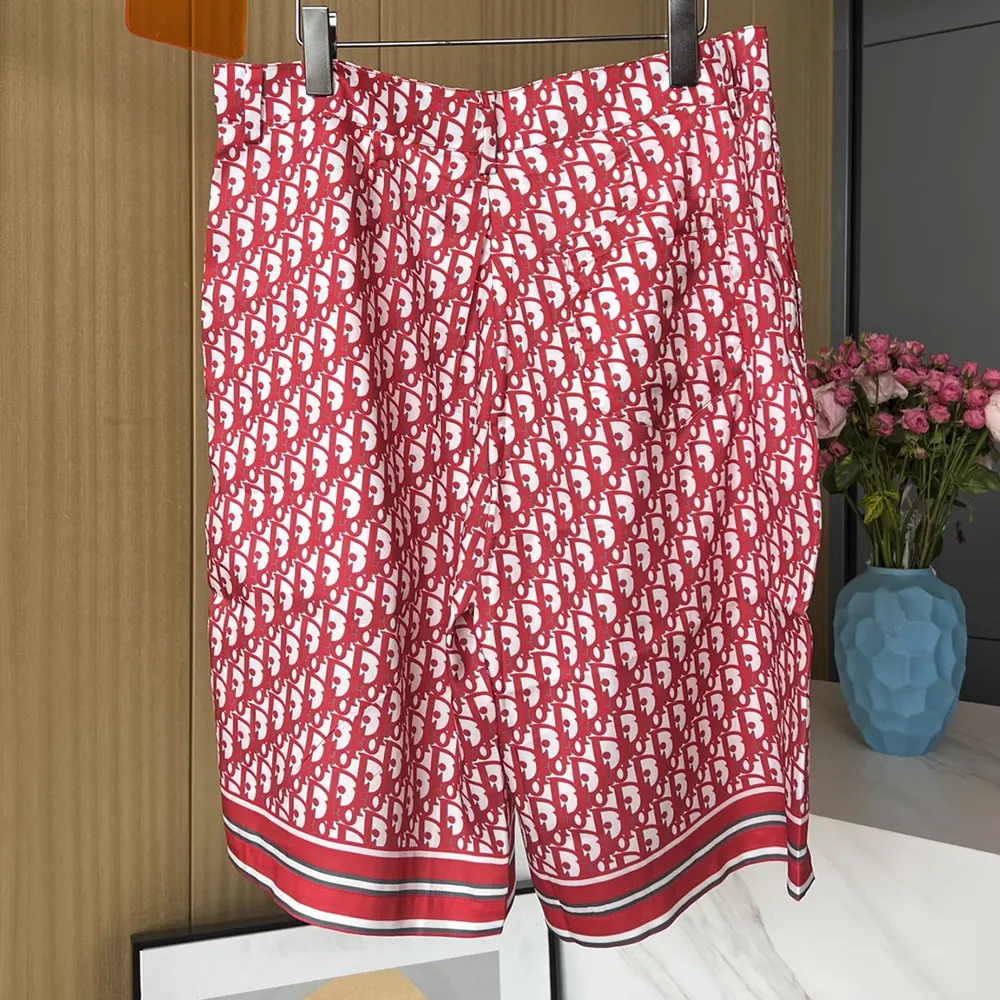 Side angle showing relaxed fit of Dior Men Oblique Bermuda Shorts