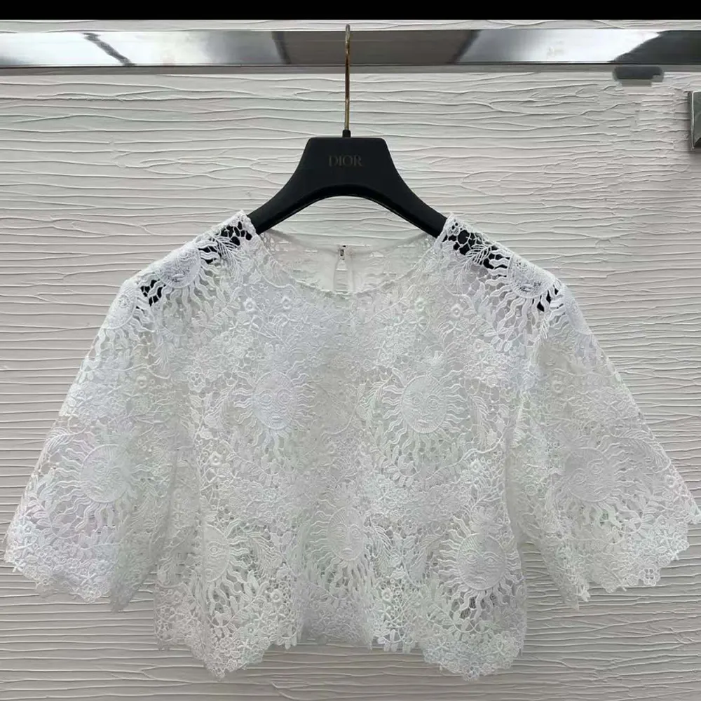 Close-up of Toile de Jouy Soleil lace detailing on Dioriviera top