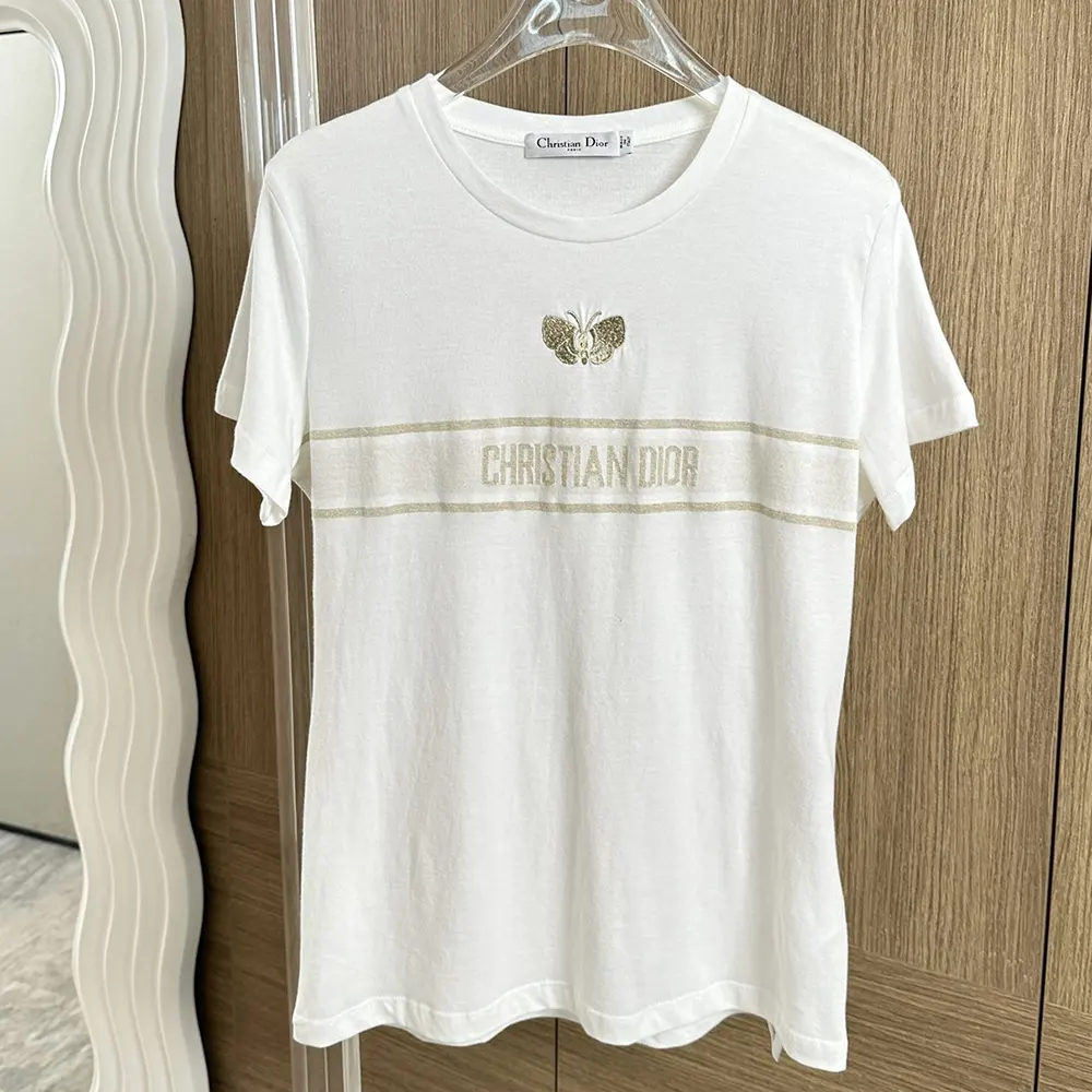 Close-up of Dior embroidery detail on white cotton jersey T-shirt
