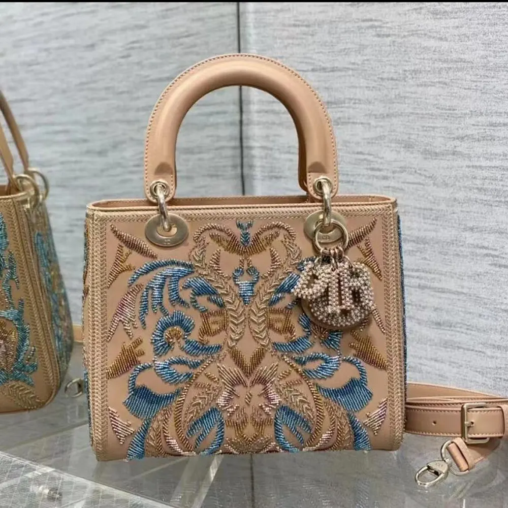 Side profile showing gold hardware and strap of Dior Women Small Lady Bag