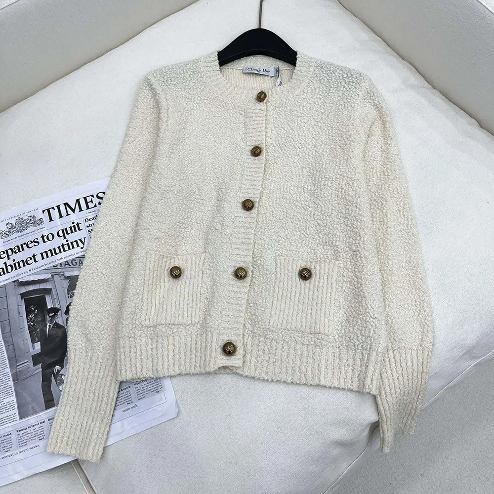 Close-up of signature Dior buttons on twinset knit in ecru white