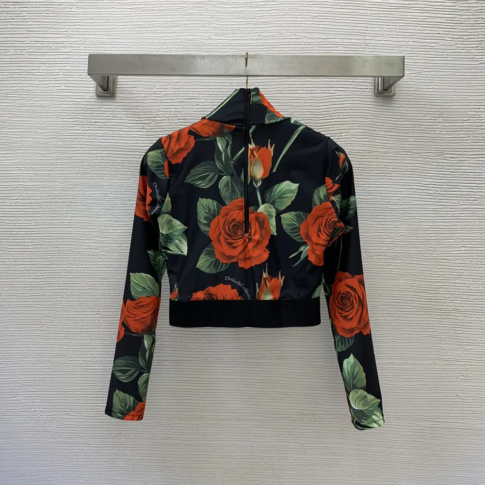 Close-up of bold rose print on black background swimsuit by Dolce Gabbana D&G