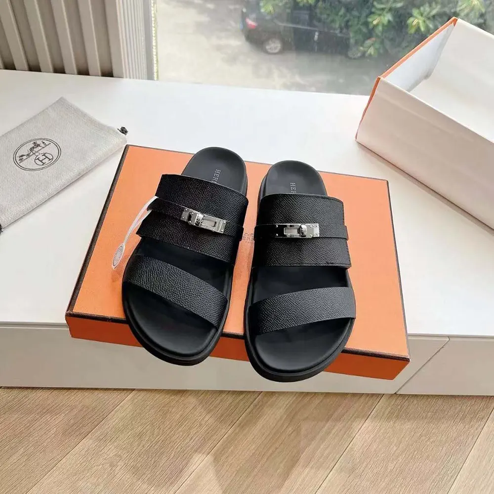 Close-up of signature Hermes H-logo hardware on Jackson Sandal