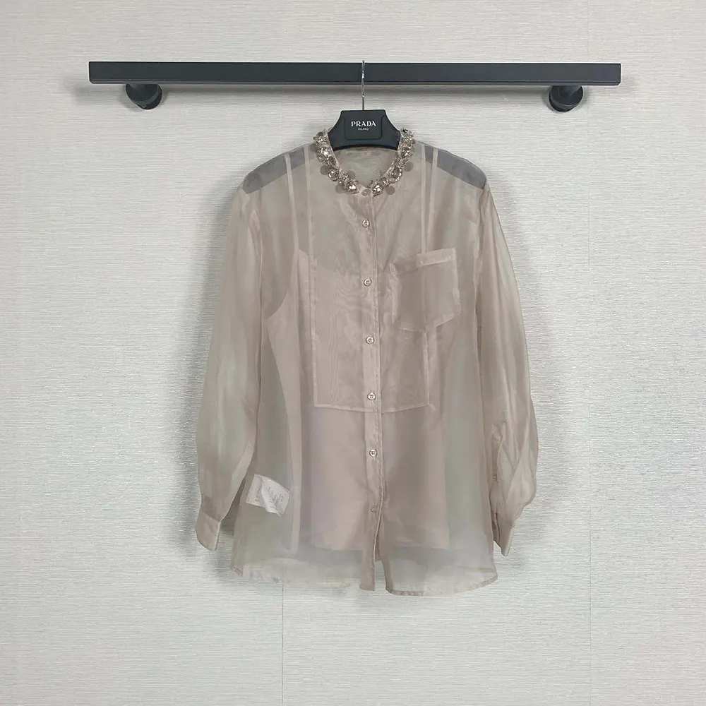 Side profile showing sheer fabric and button closure on Prada Organza Shirt