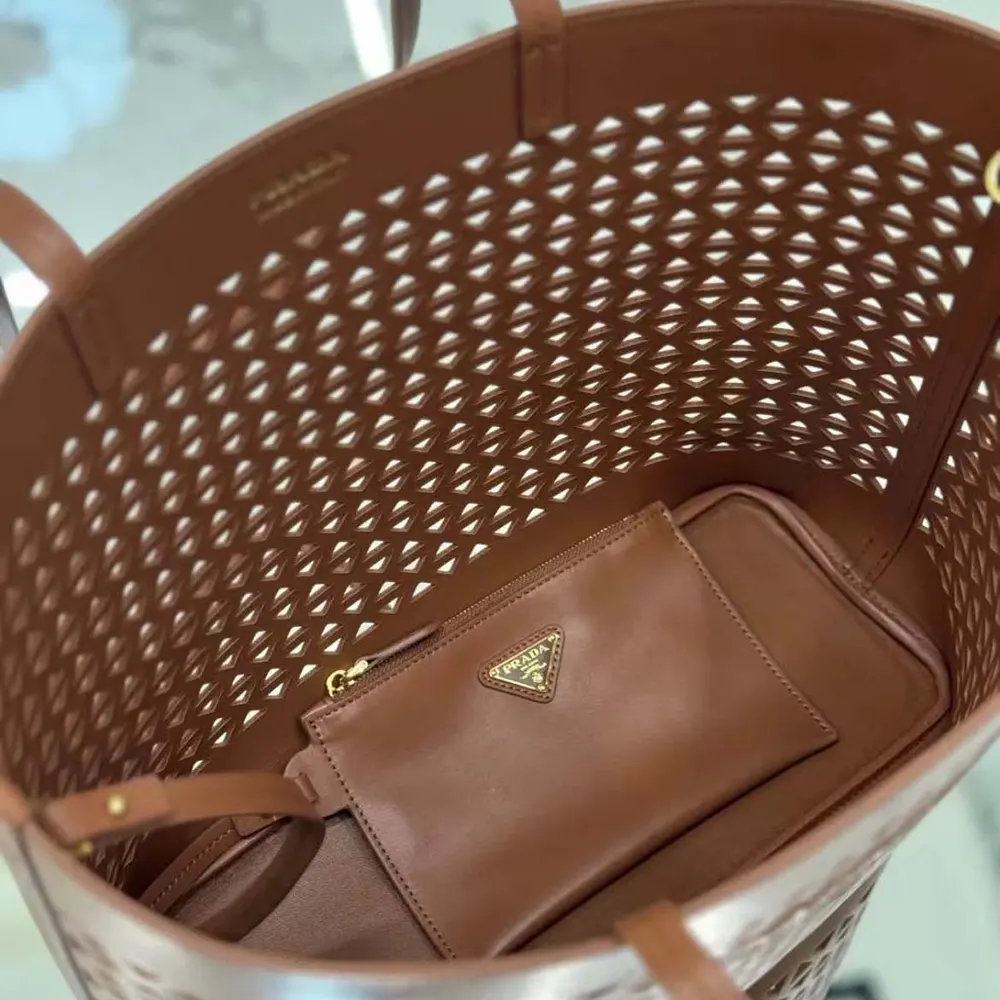Side angle showing spacious shape of Prada Women Large Perforated Leather Tote Bag