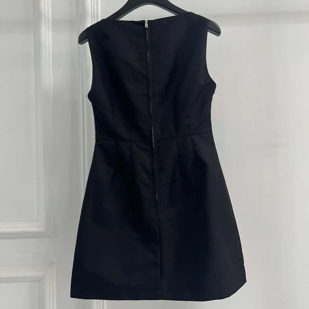 Side profile showing fitted silhouette of Prada Women Re-Nylon Mini-dress