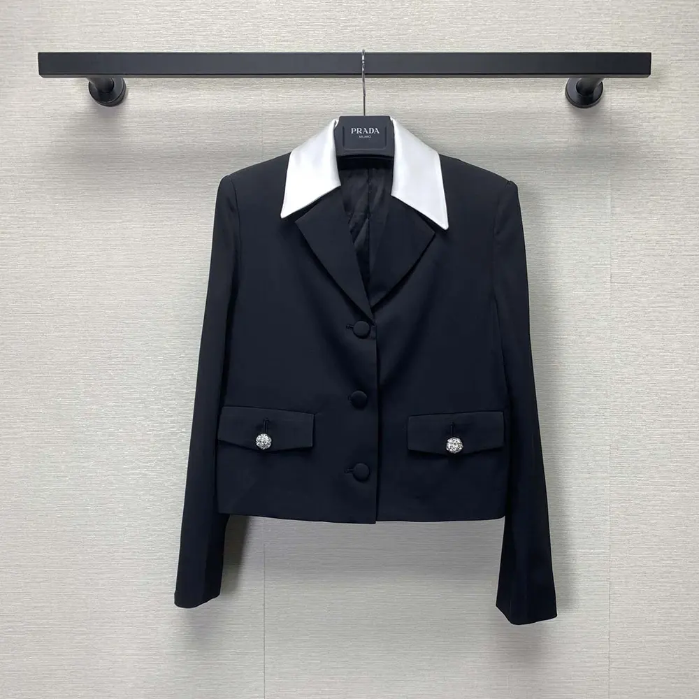 Close-up detail of satin lapel and signature Prada hardware