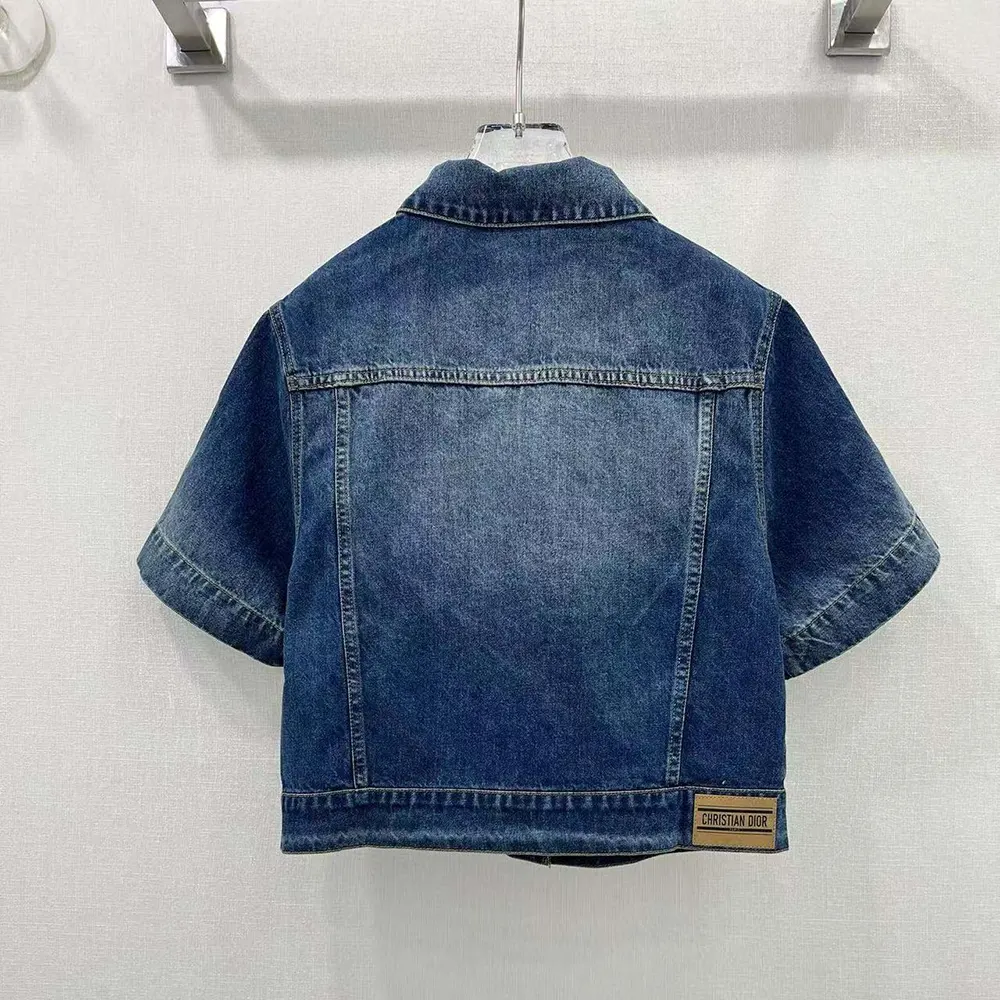 Close-up of button closure and stonewashed denim texture on Dior Women Jacket