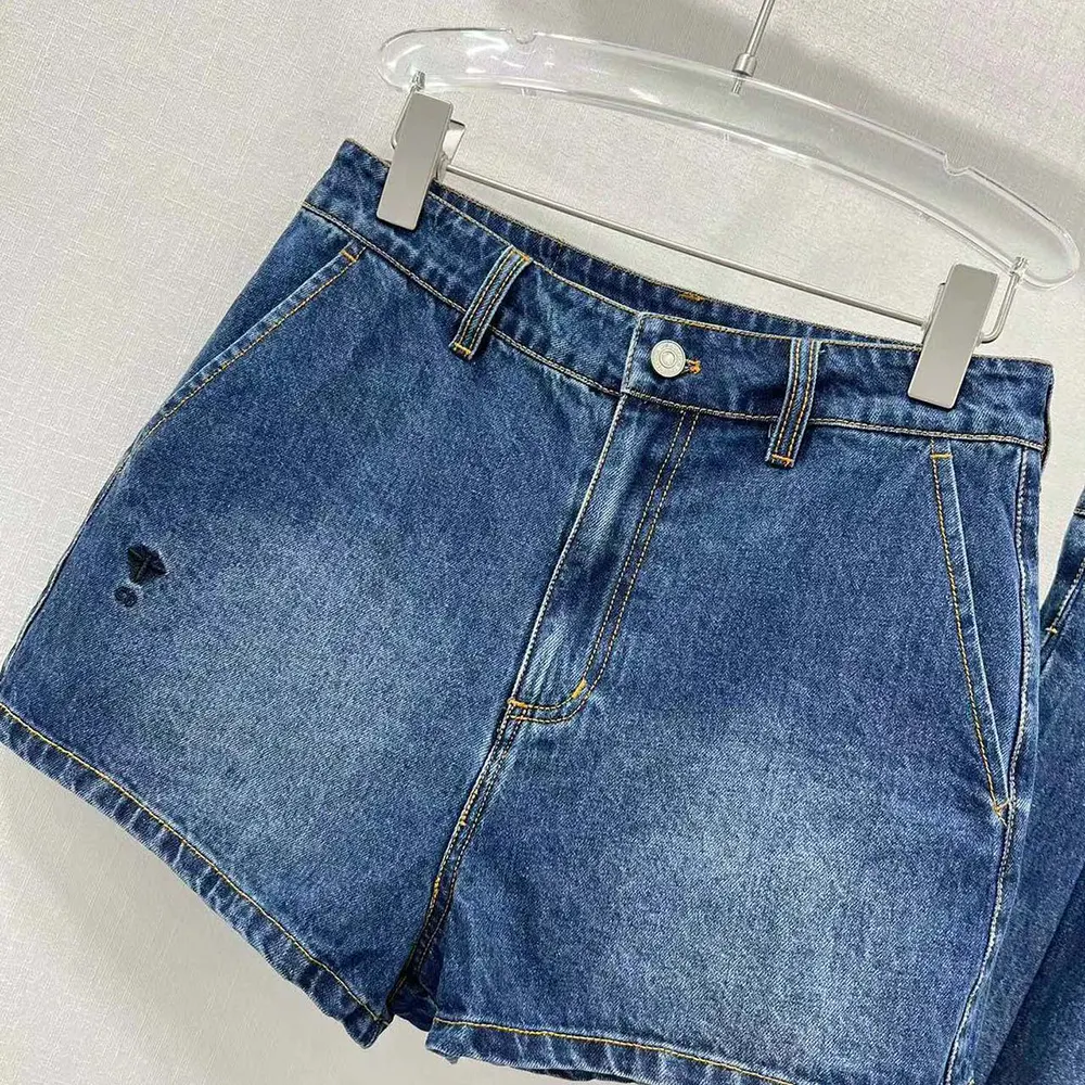 Close-up detail of button and stitching on Dior Women Shorts Blue Stonewashed Cotton Denim