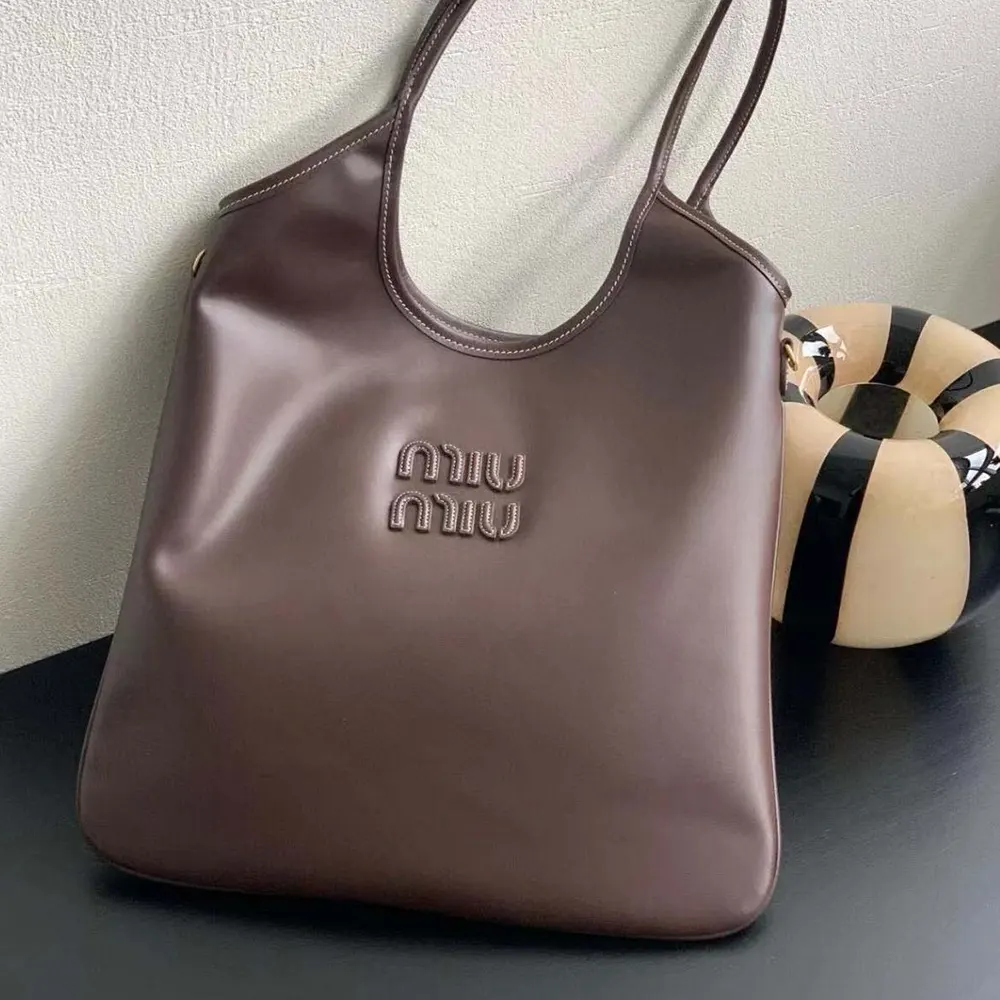Close-up on gold-tone hardware and signature detail of Miu Miu Women IVY Leather Bag-Chocolate