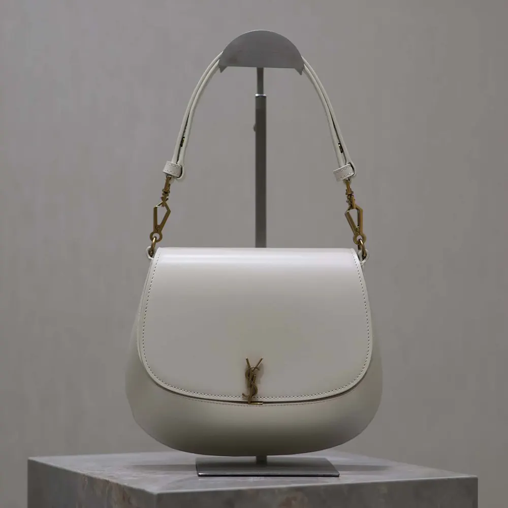 Close-up of YSL gold hardware on Voltaire Top Handle bag in white box leather