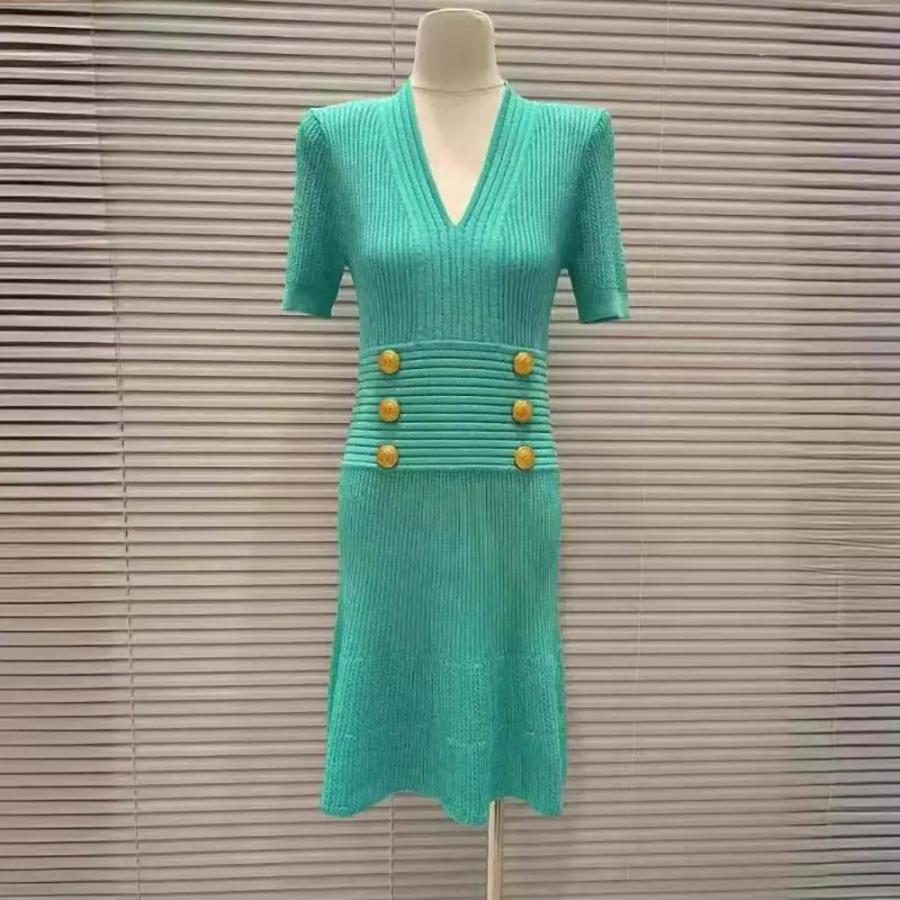 Close-up of knit texture and signature details on Balmain dress