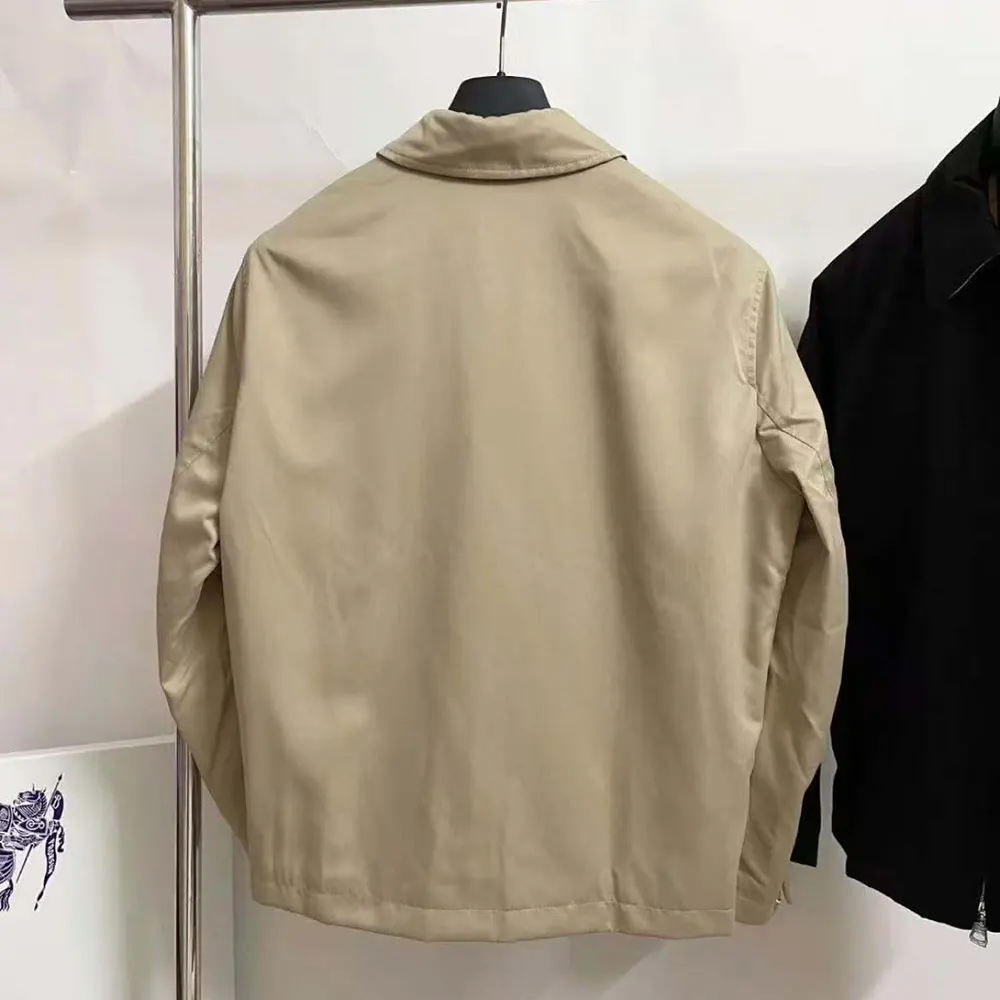 Side profile showing button and zip closure on Burberry Harrington jacket