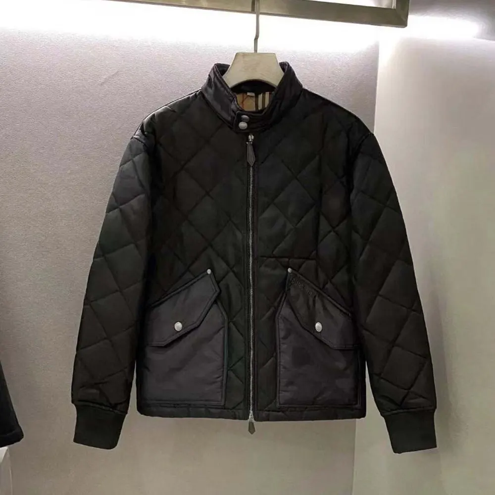Close-up of quilted fabric and branded hardware on Burberry jacket