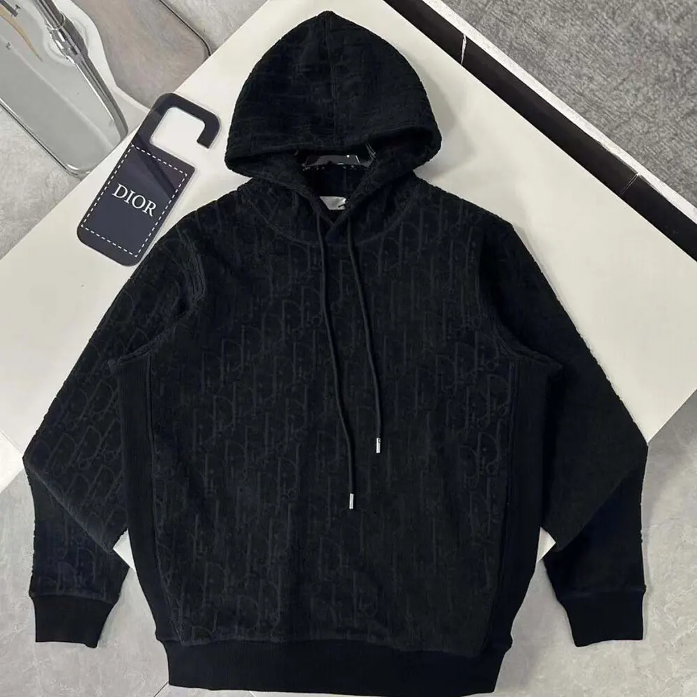 Close-up detail of Dior Oblique jacquard pattern on black sweatshirt