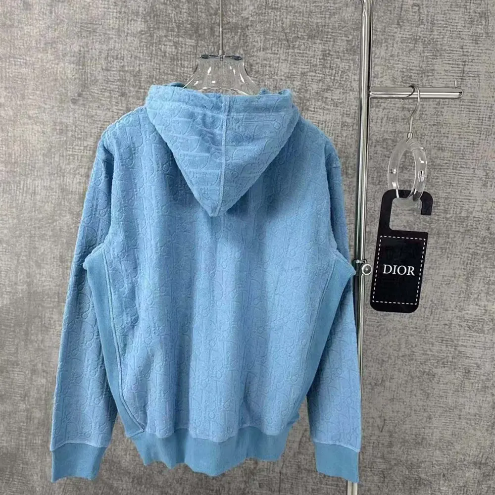 Side angle showing relaxed fit and adjustable hood of Dior sweatshirt