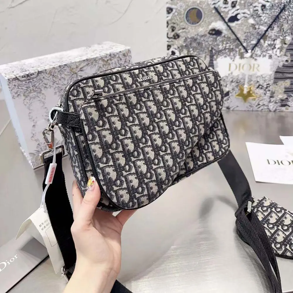 Close-up of silver hardware and jacquard fabric on Dior Men Saddle Triple Pouch