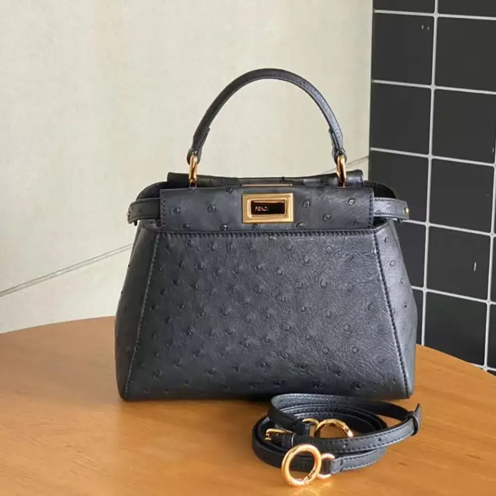 Close-up of gold-tone turn-lock on Fendi Peekaboo Mini black ostrich bag