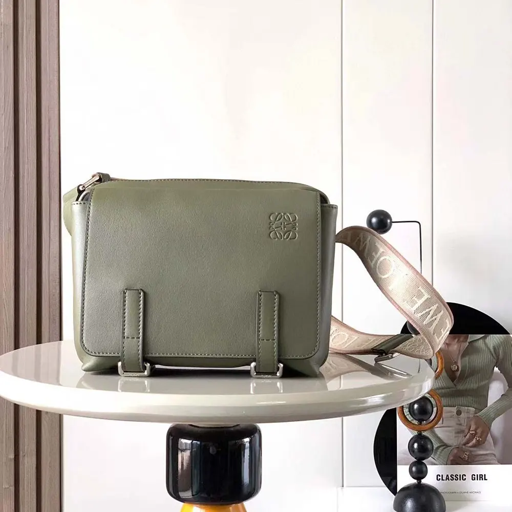 Close-up of jacquard fabric and brushed metal hardware on Loewe messenger bag