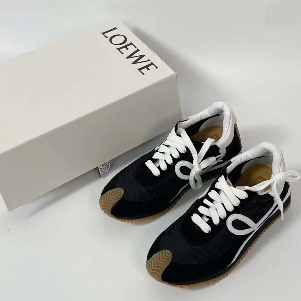 Close-up on Loewe embossed logo hardware detail on Flow Runner sneaker