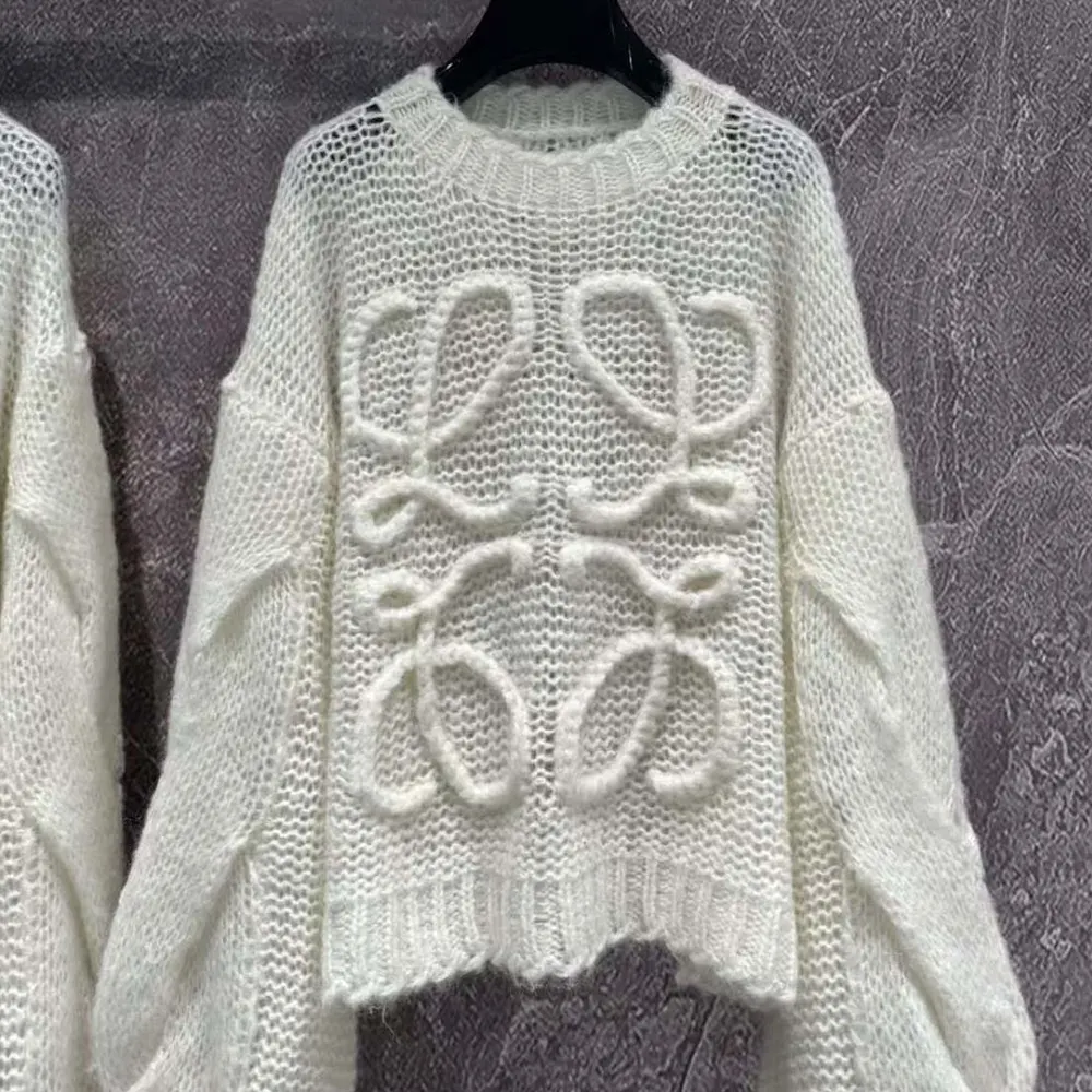 Close-up of embroidered Loewe Anagram on white mohair sweater sleeve