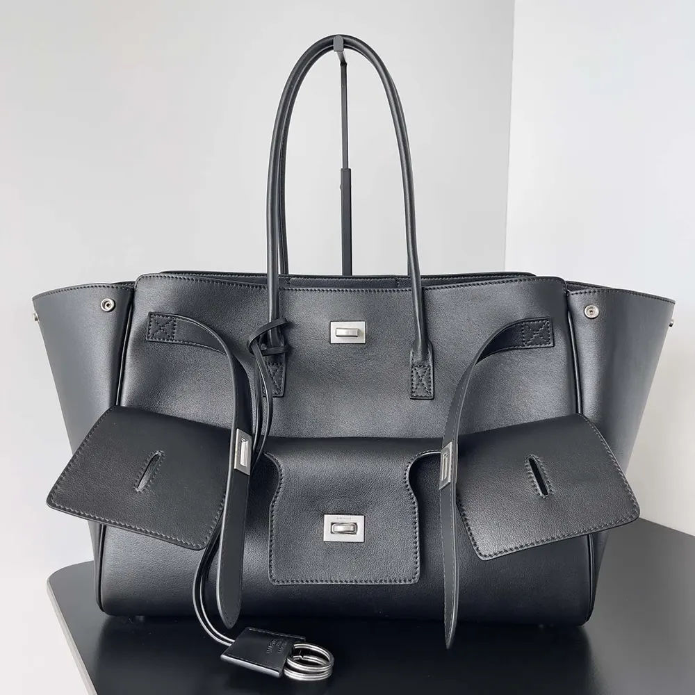 Close-up of smooth black calfskin and silver hardware on Balenciaga carry all bag