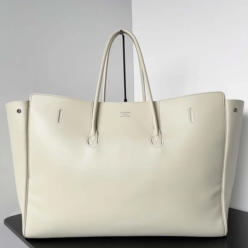 Side profile showing structured silhouette of Balenciaga Women Bel Air Medium Carry All Bag