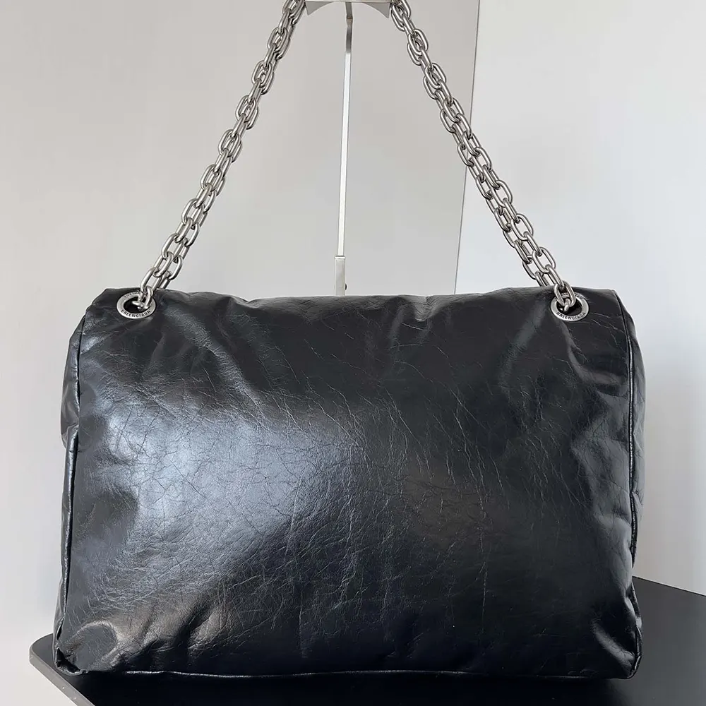 Side angle of Balenciaga Women Monaco Large Chain Bag-Black showing silhouette