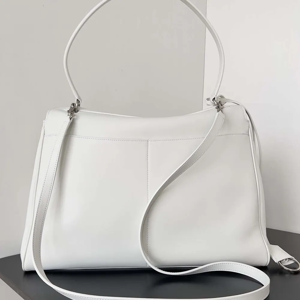 Side profile showcasing silhouette of Balenciaga Rodeo Large Handbag in white