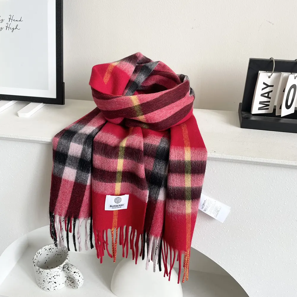 Close-up of red check pattern and fringed edge on Burberry scarf