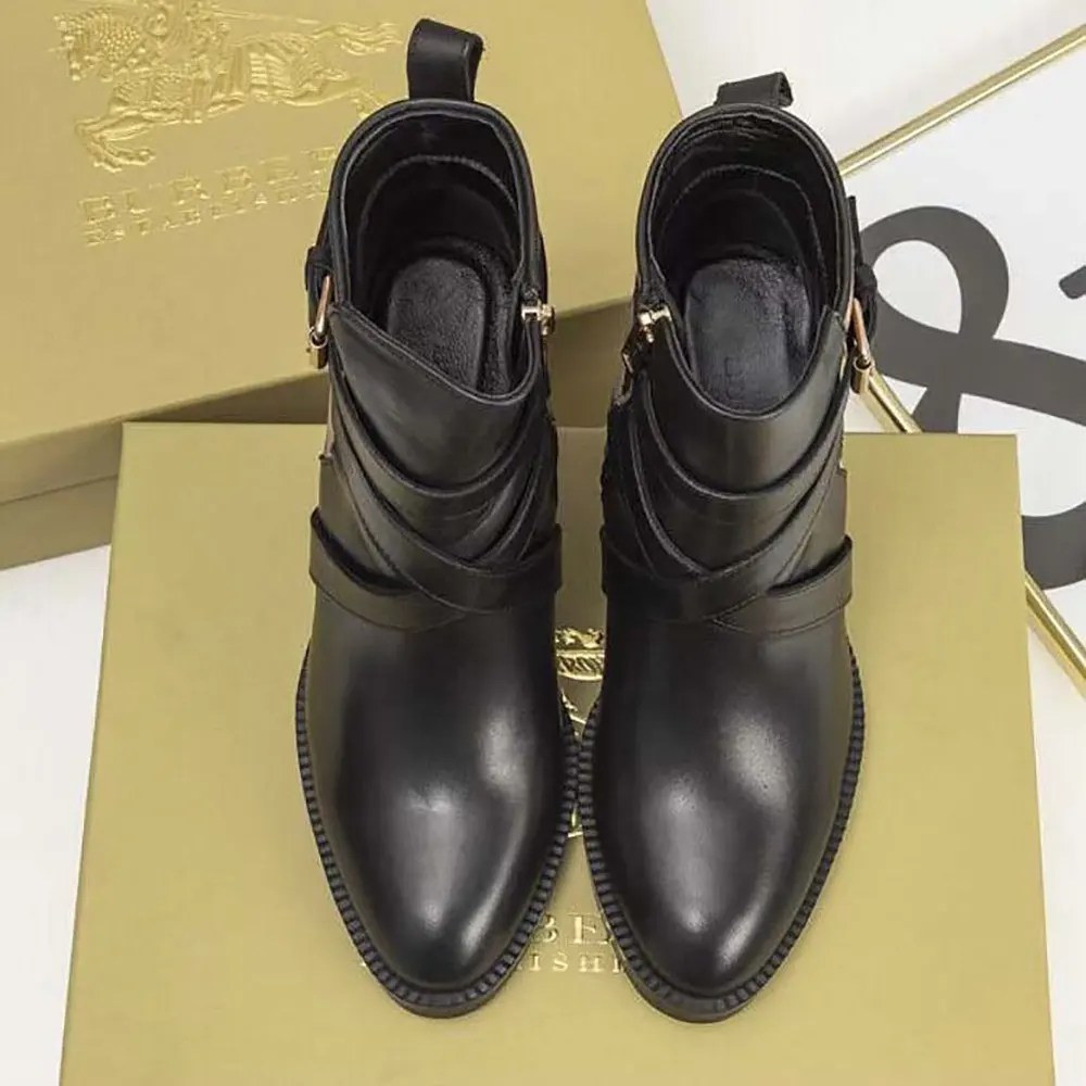 Close-up of black leather and House Check detail on ankle boots
