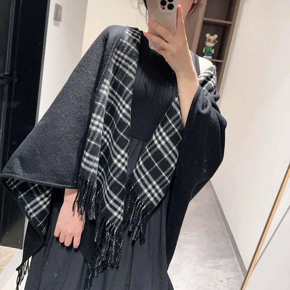 Side angle highlighting drape and silhouette of Burberry Women Reversible Check Wool Cape-Black