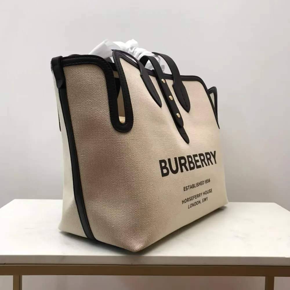 Side view showing adjustable strap of Burberry Women The Medium Soft Cotton Canvas Belt Bag-Beige