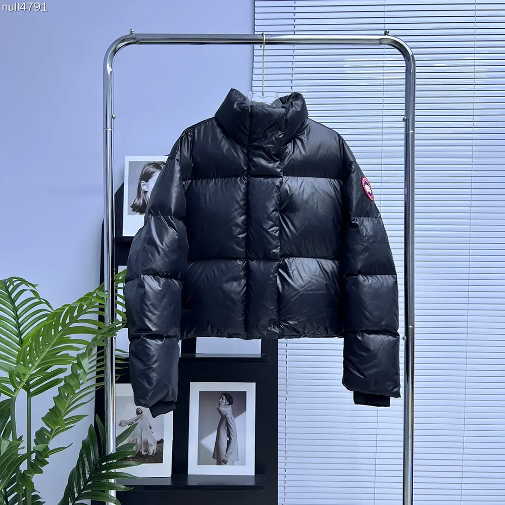 Close-up of signature badge on Canada Goose Women Cypress Cropped Puffer
